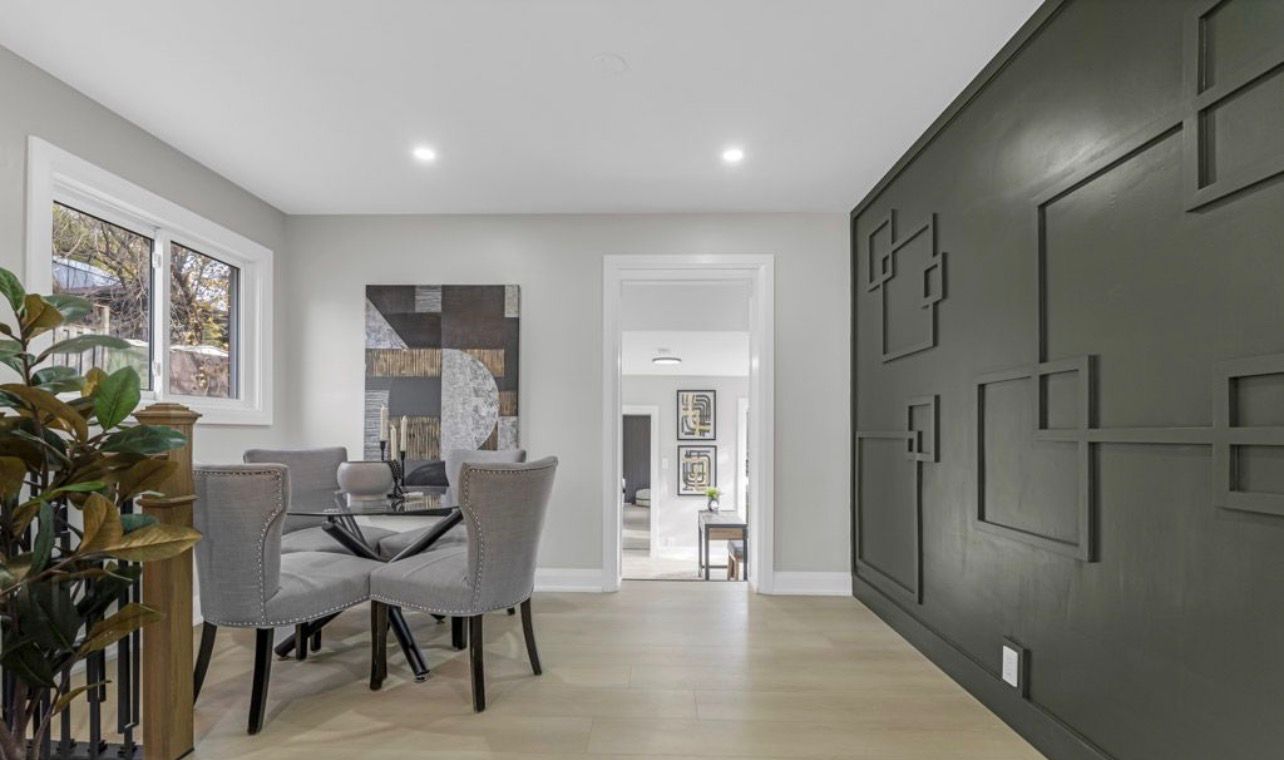 Dining room with custom sage green feature wall and open floor plan by LevelUp Renos, London Ontario
