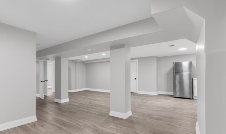 Finished open basement with recessed lighting by LevelUp Renos, London Ontario