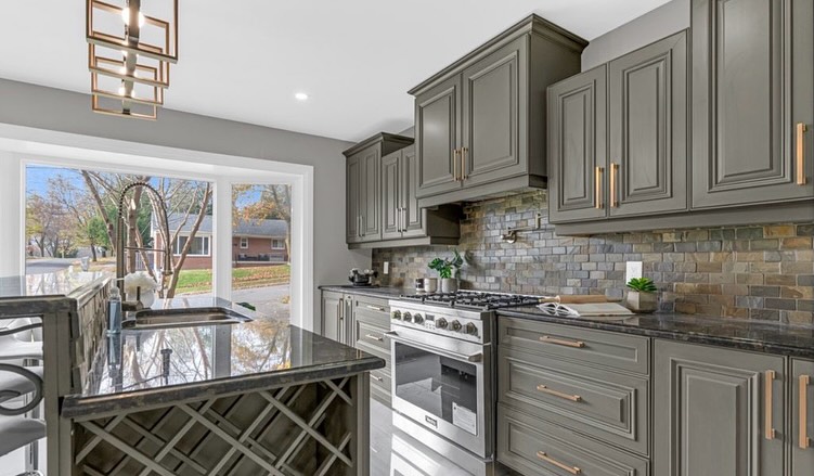 Kitchen renovation with grey cabinets and stone backsplash by LevelUp Renos, London Ontario