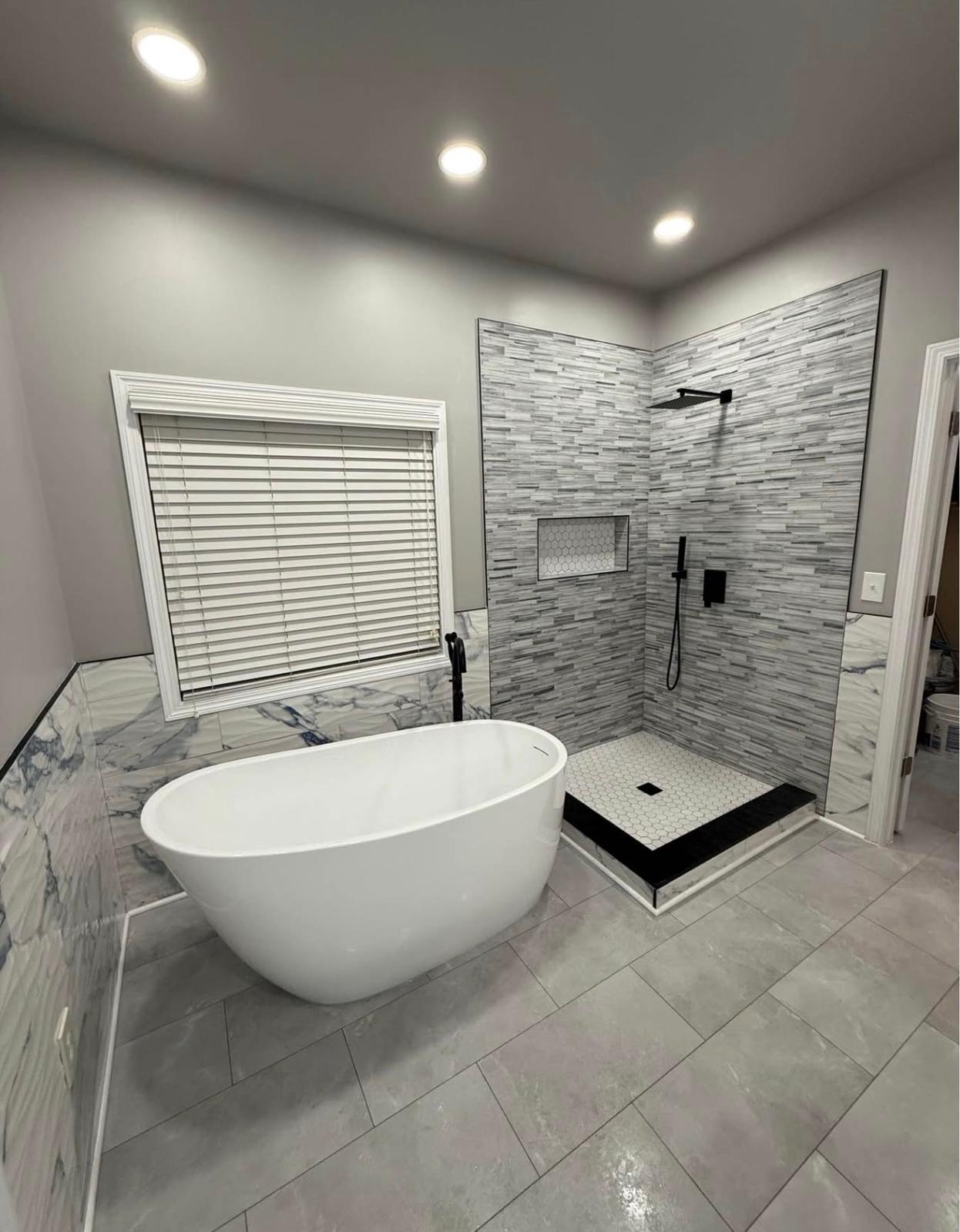 Luxury bathroom with freestanding tub and custom tile shower by LevelUp Renos, London Ontario
